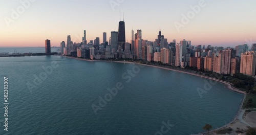 Wallpaper Mural Flying backwards above Lake Michigan and Chicago downtown at sunrise. City skyline with early morning  sky Torontodigital.ca