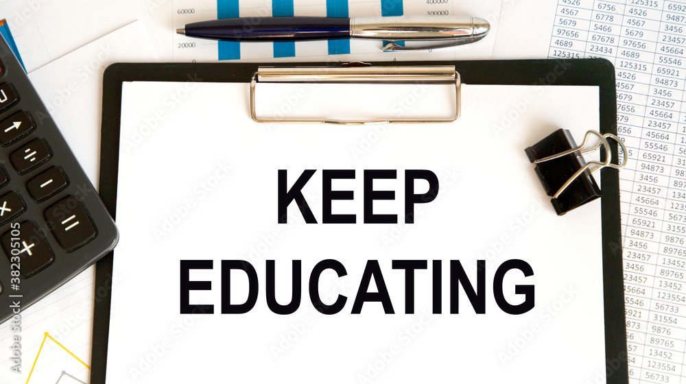 KEEP EDUCATING an inscription on a piece of paper attached to a tablet, a number of glasses and a pen, all against the background of an accountant. KEEP EDUCATING an inscription on a piece of paper attached to a tablet, a number of glasses and a pen, all against the background of an accountant.