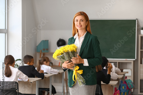 Beautiful teacher with bouq...