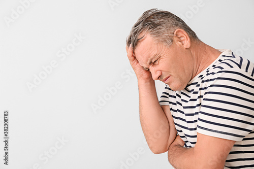 Stressed mature man on ligh...