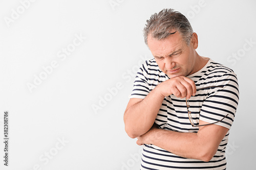 Stressed mature man on ligh...