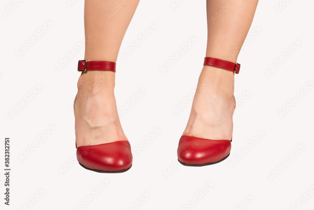 Woman in red dress and in retro red sandals on heels.