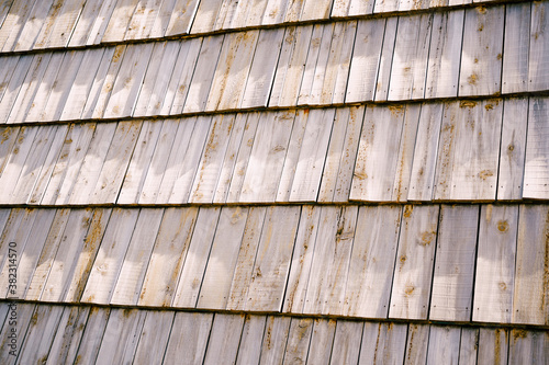Close-up texture of wooden planks lined in rows, wooden roof on a house.