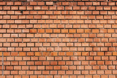 A wall of brown bricks. Close-up of brick wall texture.