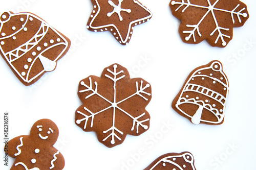 Tasty homemade Christmas gingerbread cookie of various shapes with sugar glaze on white background