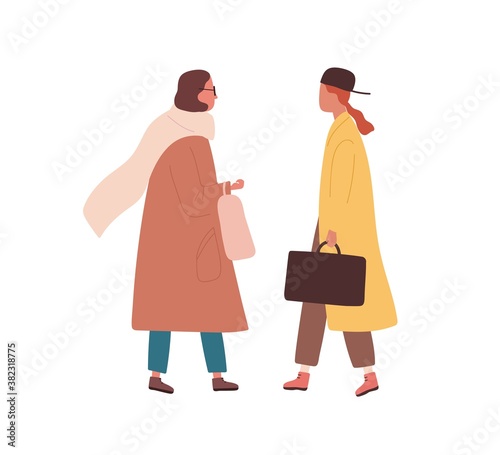 Friends meeting. Trendy women in stylish outwear talking together outdoors. F...