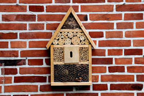 Wooden Bee House hanging on a brick wall - rural scene © Michael Lerch