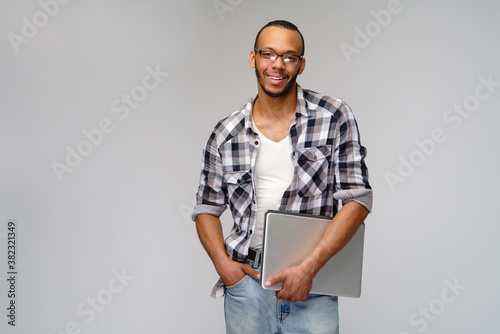 A young african american man working with a laptop pc
