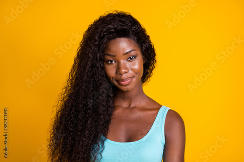 Canvas Print Photo portrait of smug african american woman smirking wearing blue tank-top iso