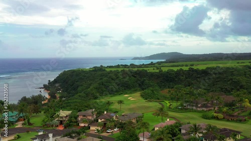 Princeville Anini Beach and golf course in aerial drone shot. Kauai Hawaii. Ocean colored brown by heavy rainfall photo