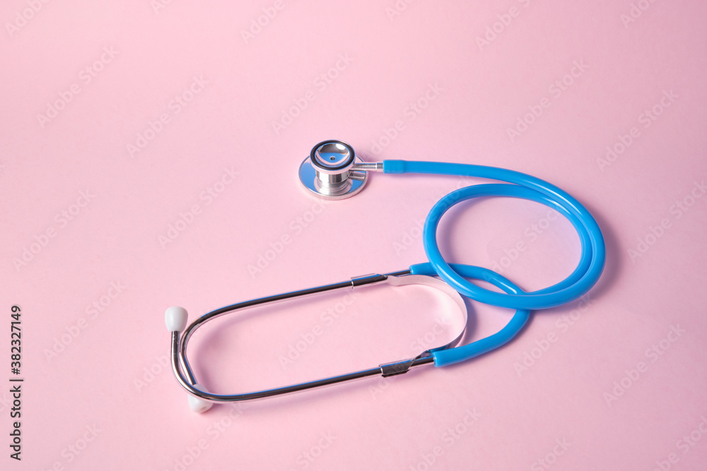 blue stethoscope on pink background. For check heart or health check up concept blue stethoscope on pink background. For check heart or health check up concept