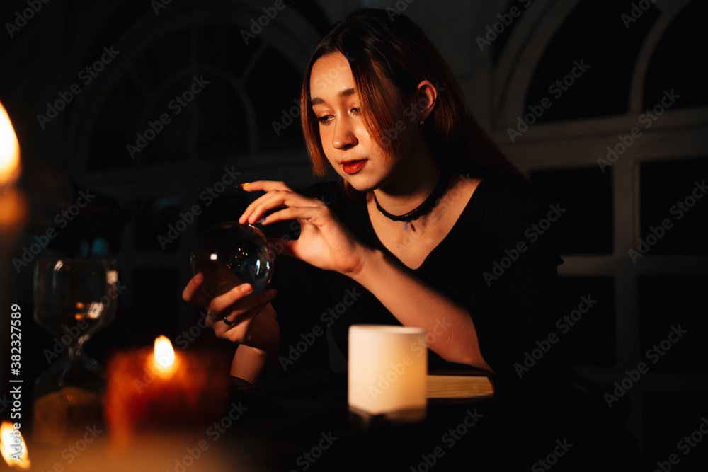 Beautiful long hair woman fortune teller with crystal ball in dark room. Beautiful long hair woman fortune teller with crystal ball in dark room.