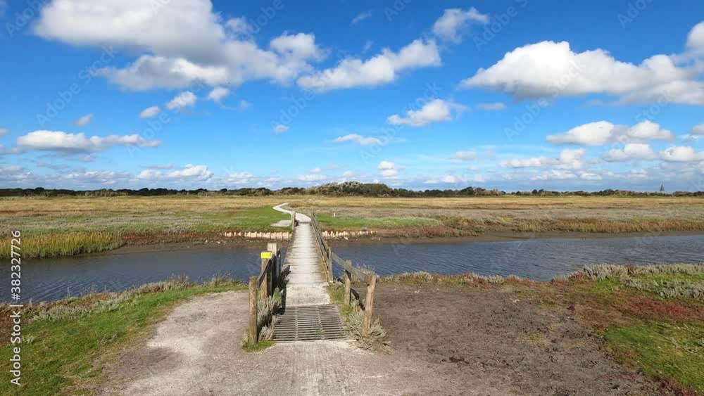 POV driving over bridge at the salt marshes of Schiermonnikoog in the Netherlands POV driving over bridge at the salt marshes of Schiermonnikoog in the Netherlands