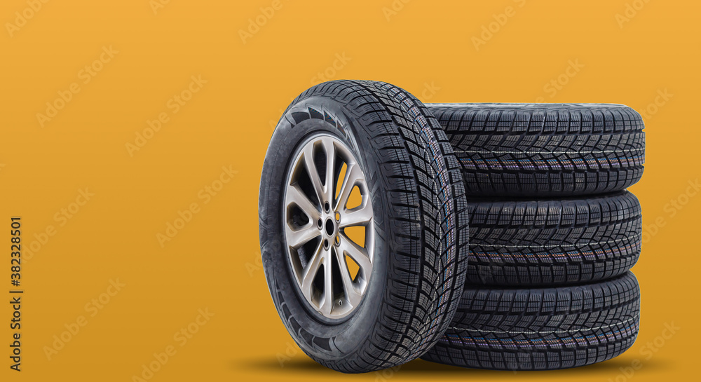 Car tires isolated on yellow background Car tires isolated on yellow background