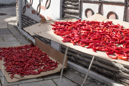 Drying hot peppers on the road. dry chilli under the sun. photo