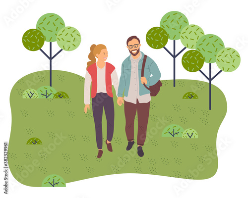 Couple walking in a park. Young guy and girl holding hands walking in summer garden, weekend walk. Lovers man and woman met on a date outdoor. Romantic promenade in the open air, active lifestyle