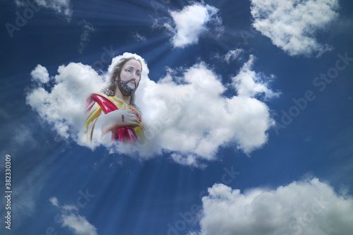 Jesus Christ on white clouds with light ray at heaven. religion,