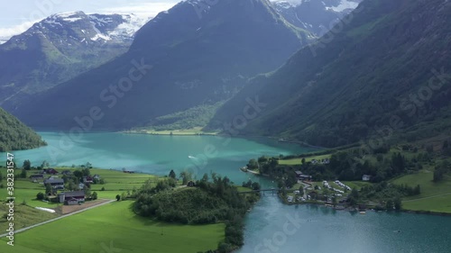 Aerial drone footage over the beautiful lake Oldevatnet in Stryn, Norway. Briksdalsbreen turquoise glacier water in summer time photo
