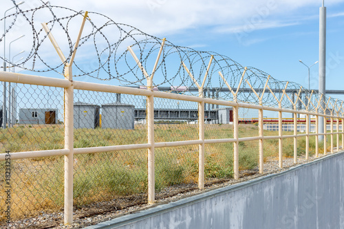 the territory is guarded by a high fence with barbed wire