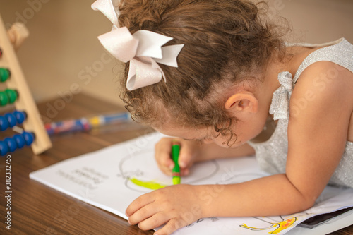 Little girl with abacus and coloring book.