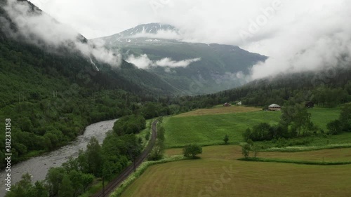 Gaustatoppen aerial drone view from Rjukan valley flying towards mountain peak. Beautiful cloudy morning in summer time photo