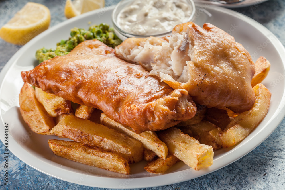 Fish in beer batter and chips with green pea and tartar sauce Fish in beer batter and chips with green pea and tartar sauce