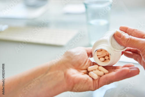 Patient pours pills on his hand