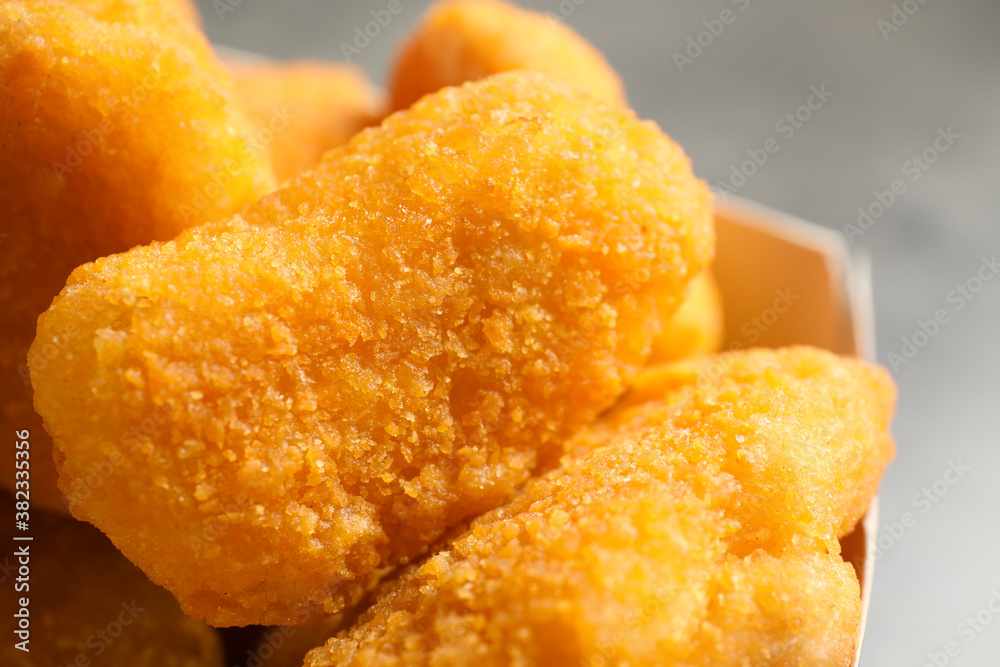 Tasty fried chicken nuggets on light background, closeup Tasty fried chicken nuggets on light background, closeup