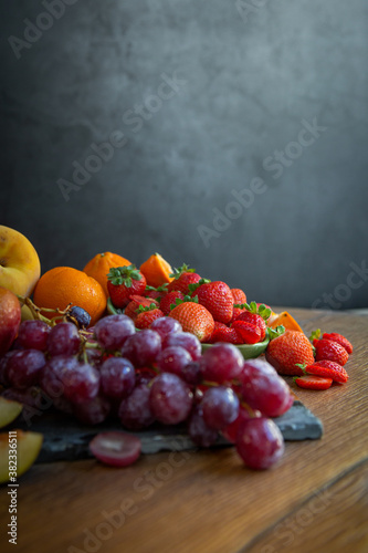 Fototapeta Naklejka Na Ścianę i Meble -  Still life of fresh seasonal fruits of reddish tones