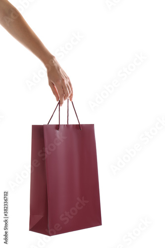Woman with paper shopping bag on white background, closeup