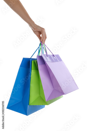 Woman with paper shopping bags on white background, closeup