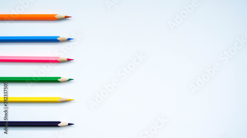 Multicolored set of wooden pencils on white background