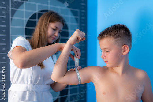 Muscle strength and volume analysis in children, anthropometric upper arm circumference tape measurement photo