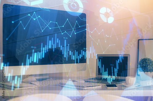 Stock market graph and table with computer background. Double exposure. Concept of financial analysis.