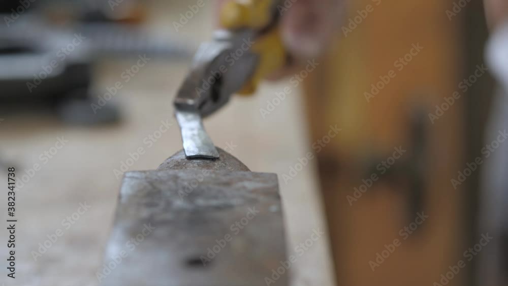 forging a hot bearing with a hammer. a blacksmith makes a chisel from a bearing. the master forges a piece of metal with a hammer forging a hot bearing with a hammer. a blacksmith makes a chisel from a bearing. the master forges a piece of metal with a hammer