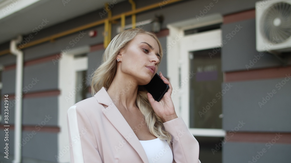 Fototapeta premium Portrait business woman talking phone at street. Woman having phone talk outdoor