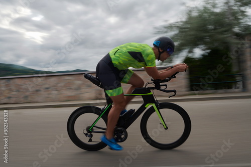 triathlon athlete riding a bike on morning training