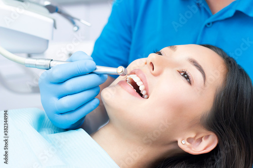 Dentist and patient in the dental office. Woman having teeth examined by dentists