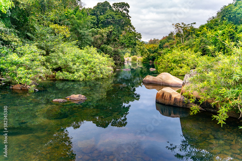 The amazing view of stream of water of waterfall in Yanoda Rain Forest national park on Hainan in China photo