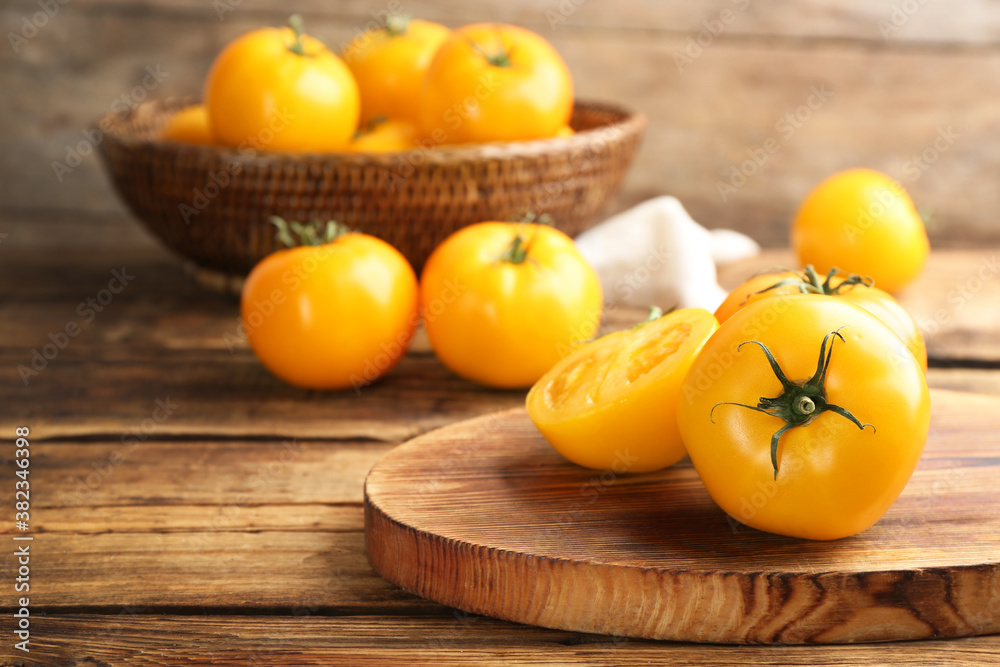 Delicious ripe yellow tomatoes on wooden table