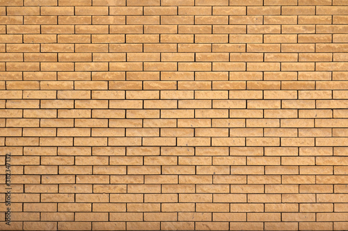 Panoramic image yellow background brick wall texture.