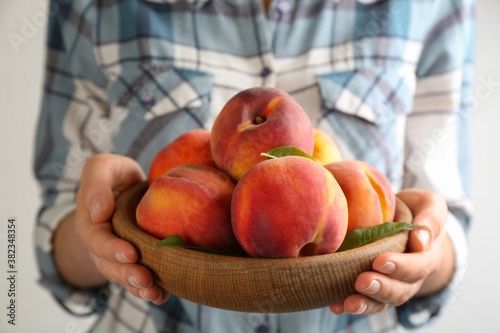 Wallpaper Mural Woman with fresh sweet peaches in bowl, closeup Torontodigital.ca