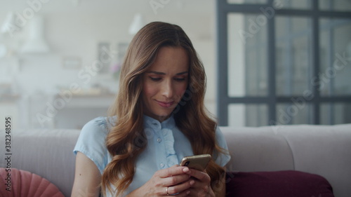 Closeup business woman chatting mobile phone at home office. Girl checking phone