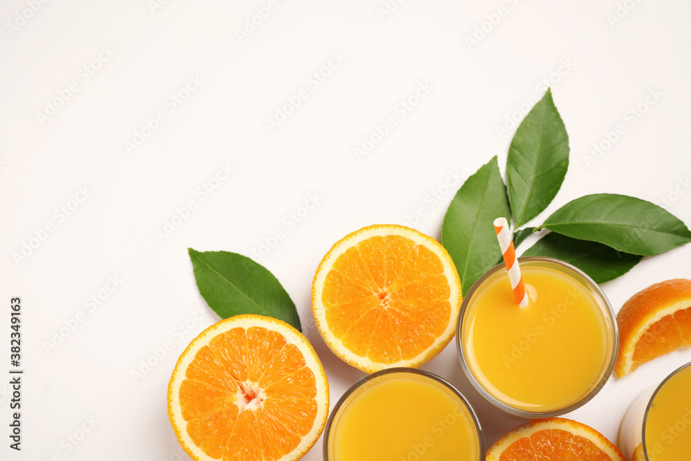 Glasses of orange juice and fresh fruits on white background, top view Glasses of orange juice and fresh fruits on white background, top view