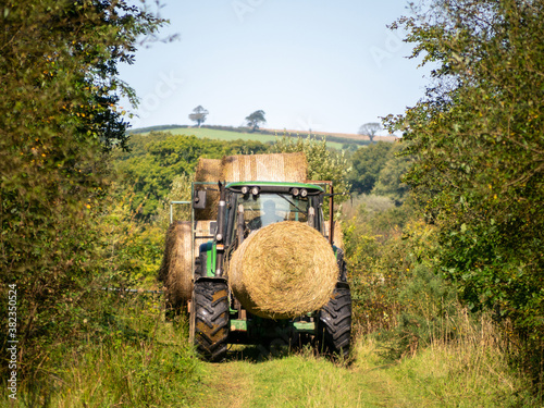 Autumn in nature, with tractor. Devon, UK. Hay bales.