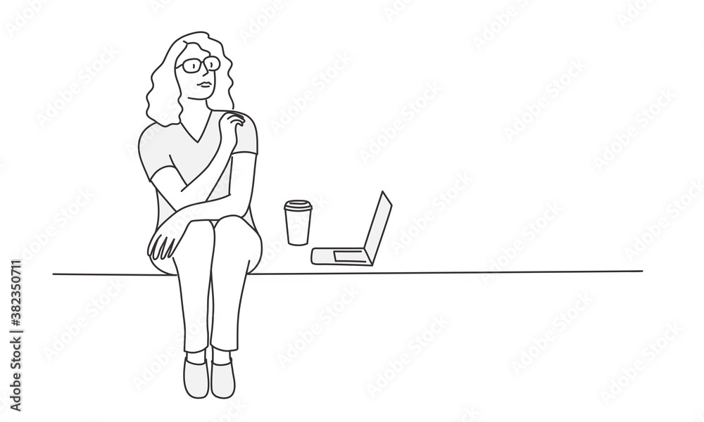 Young woman with glasses is sitting near laptop and coffee.