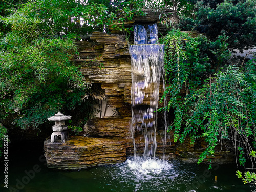 Photography Artificial waterfall & hill of rockery with traditional Chinese Jiangnan style in a corner of a small public park at Hongkou district, Shanghai, China