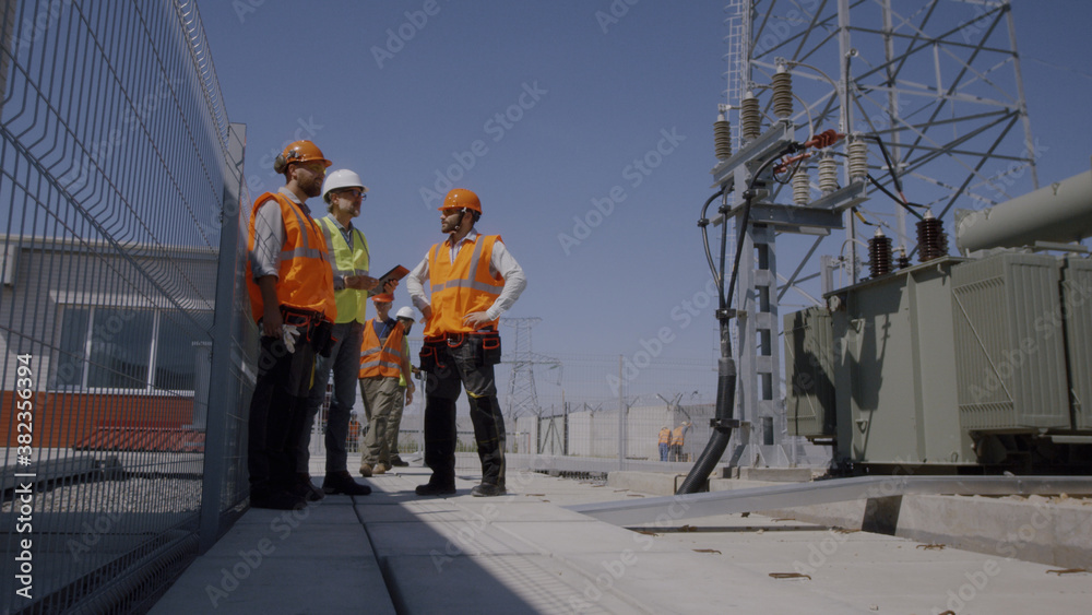 Builders discussing power plant construction