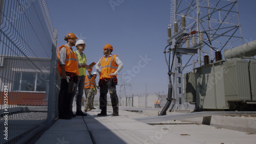 Builders discussing power plant construction © Framestock