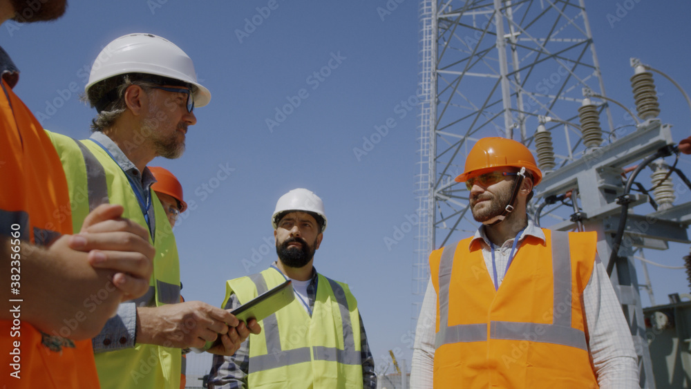Man showing power station to inspectors Man showing power station to inspectors